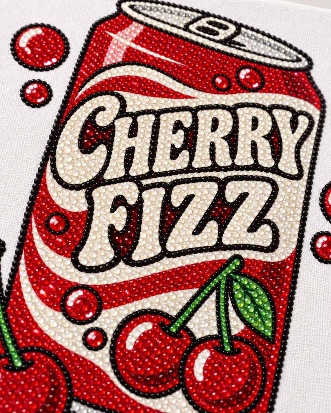 Close-up of red cream green and black rhinestones on Cherry Fizz canvas