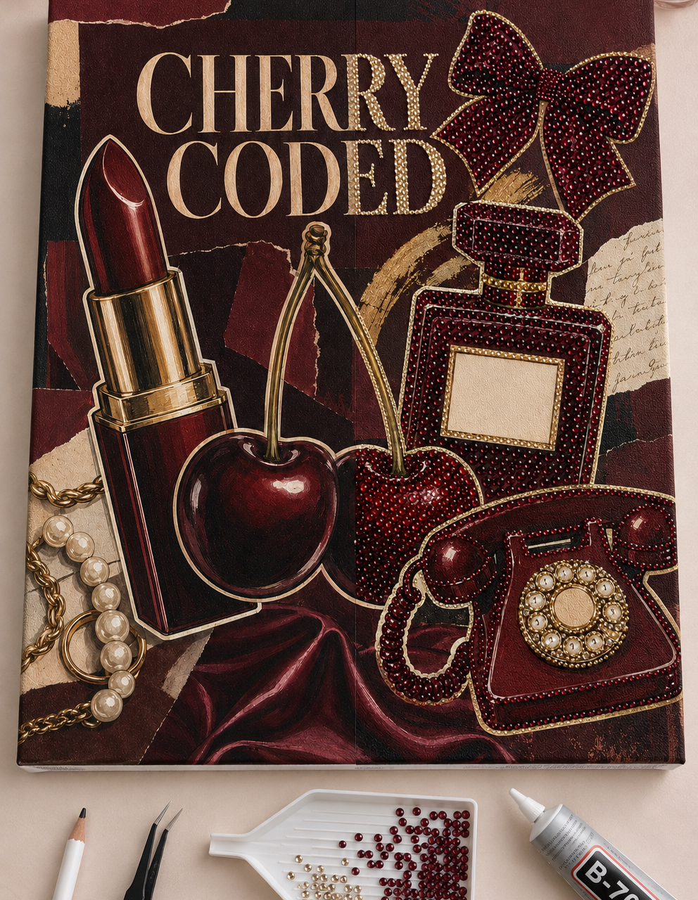 Cherry Coded canvas half completed with burgundy and champagne rhinestones beside the included tools