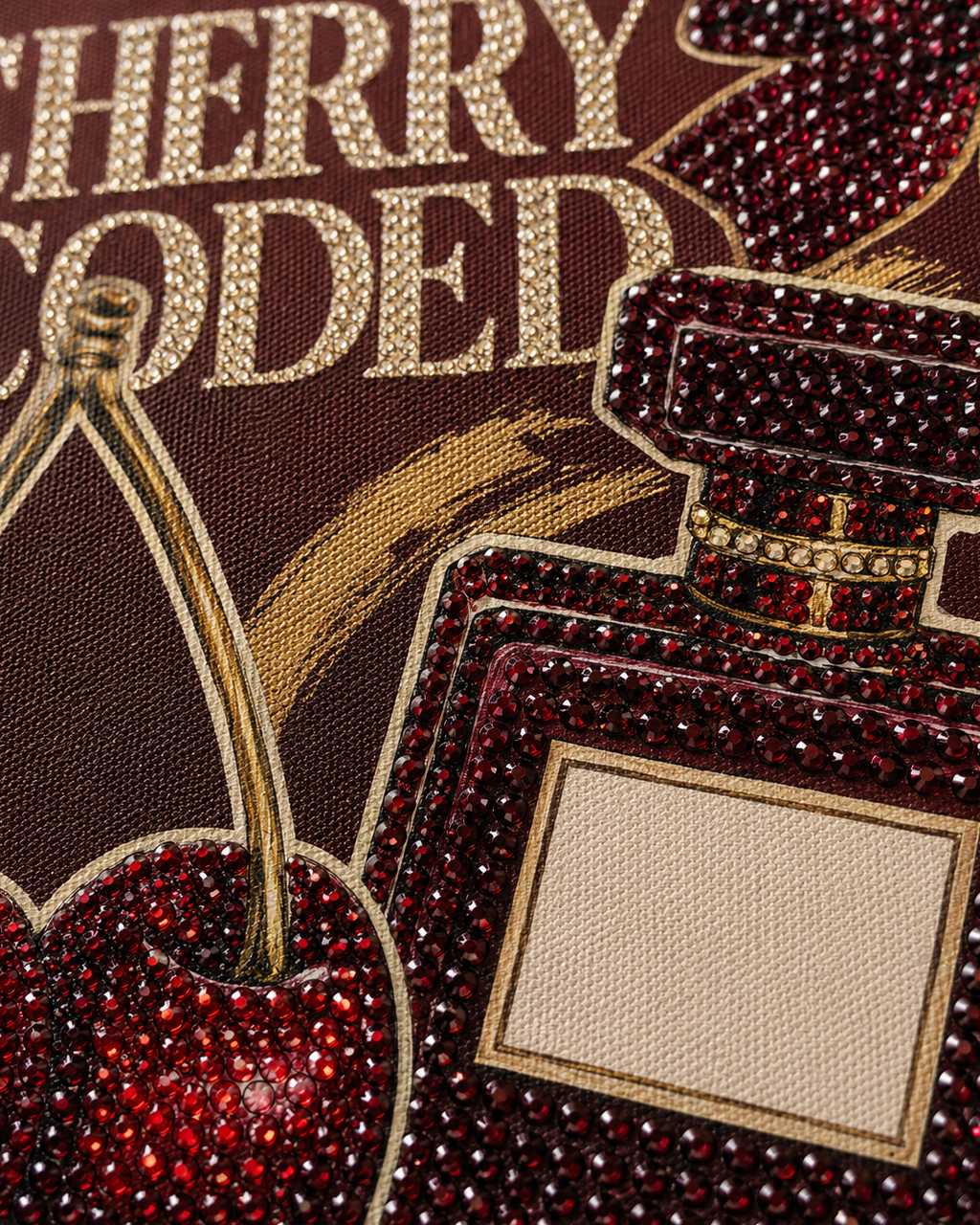 Close-up of burgundy and champagne rhinestones on the Cherry Coded canvas