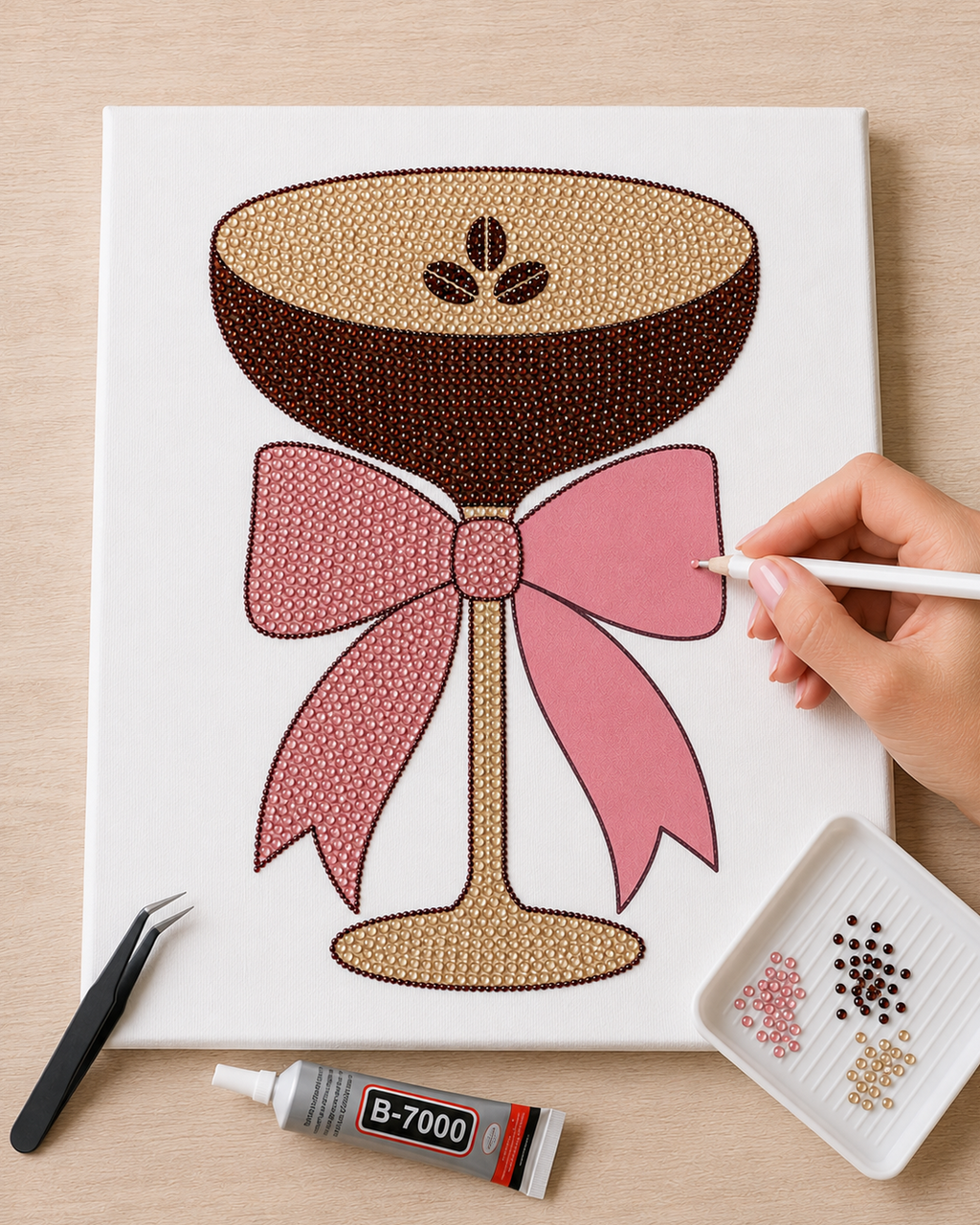 Espresso Martini canvas partly completed while a blush pink rhinestone is placed on the satin bow
