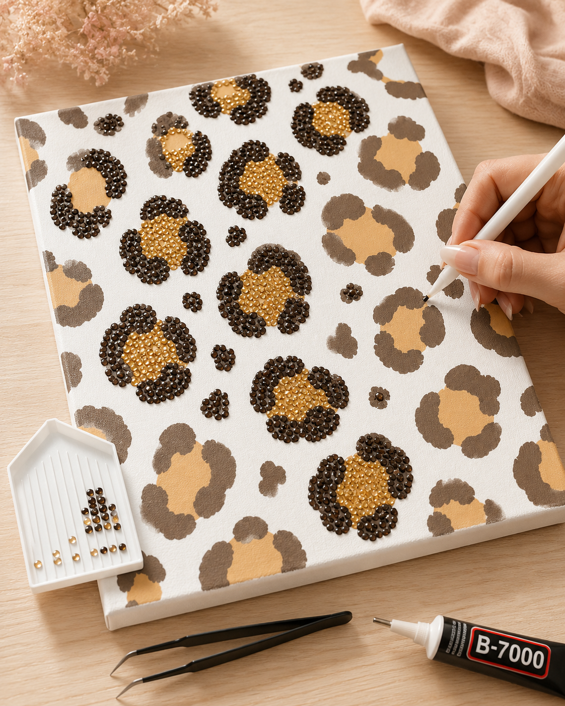 Leopard Print DIY bedazzle canvas being decorated by hand