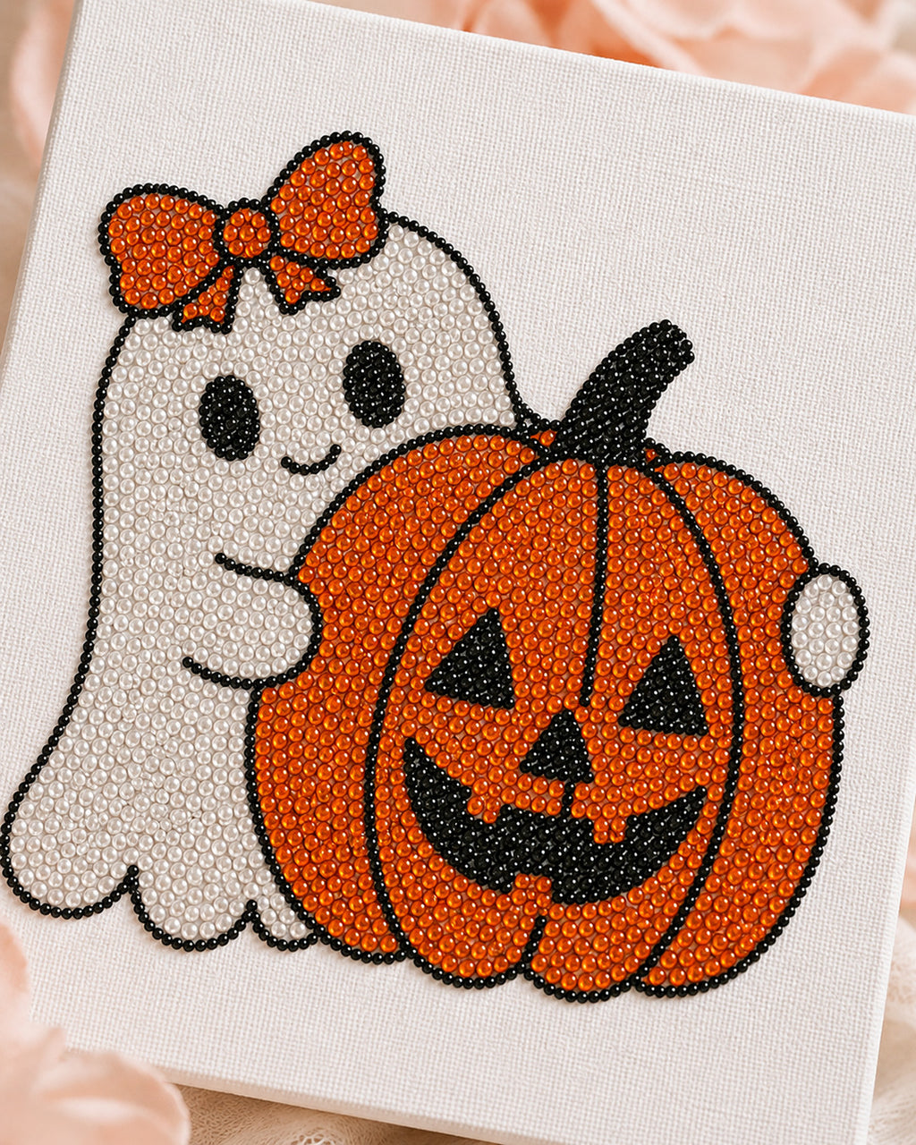 Close-up of white orange and black rhinestones on the Pumpkin Boo Halloween canvas