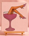 Finished Rosé in Heels rhinestone canvas displayed on a wooden easel