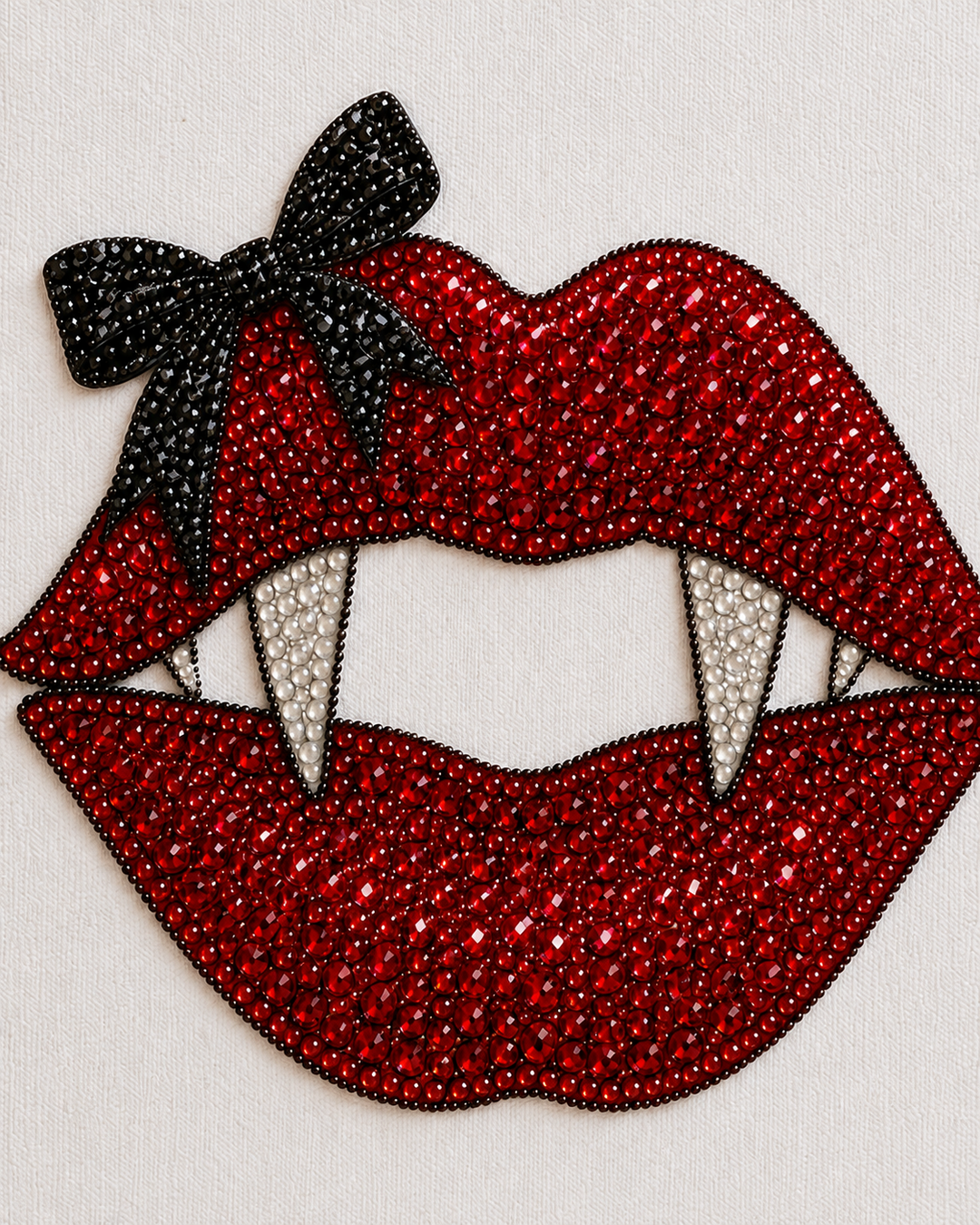 Close-up of red, black and clear rhinestones on the Vampire Kiss Halloween canvas design
