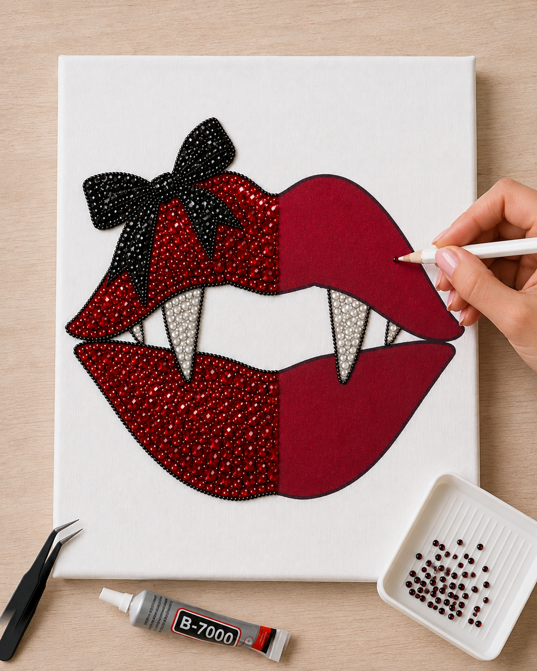 Vampire Kiss canvas in progress with the white wax pencil placing a red rhinestone on the red lips
