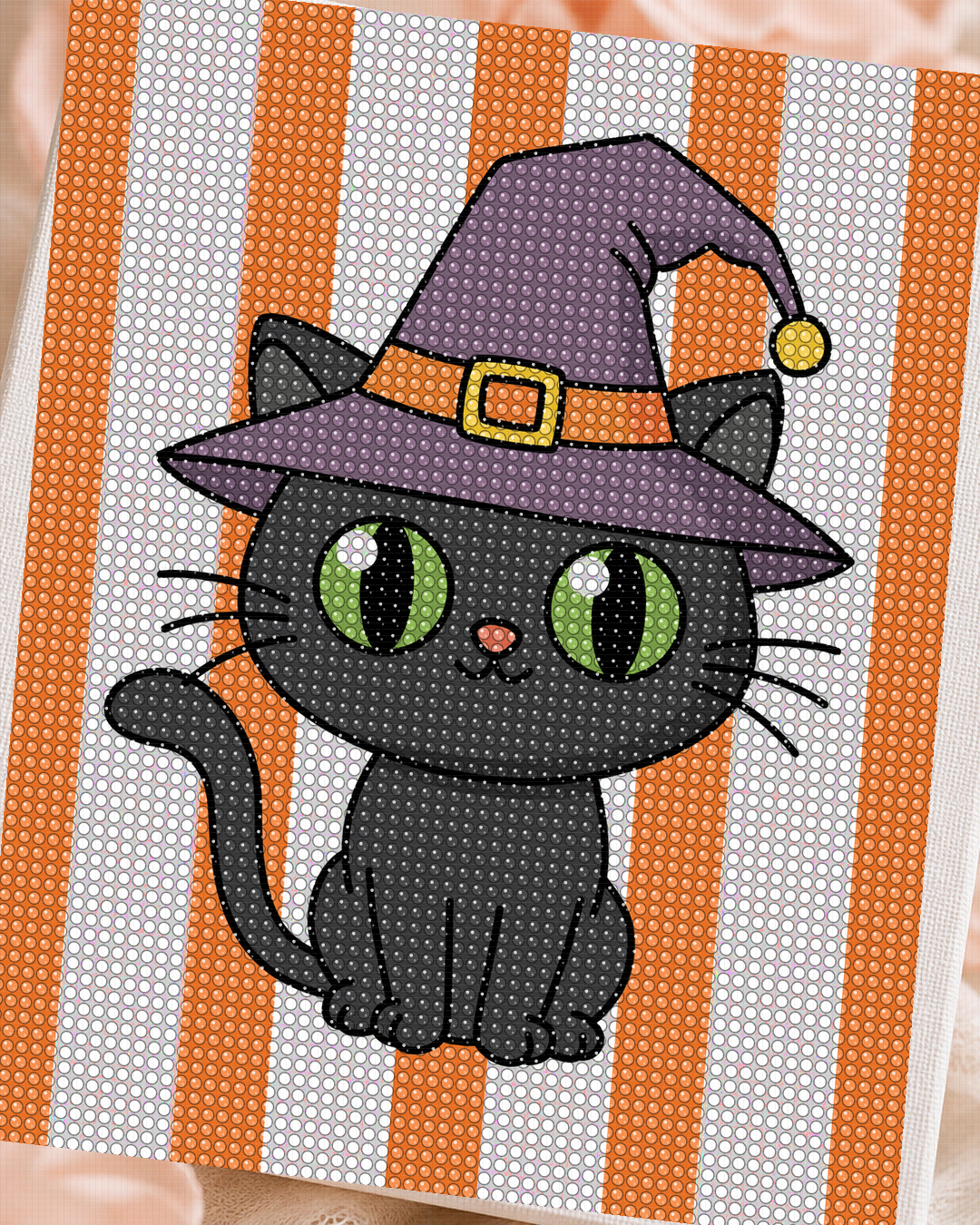Close-up of orange purple black green and white rhinestones on the Witch Cat canvas