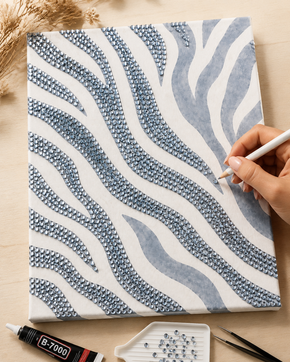 Zebra Print DIY bedazzle canvas being decorated by hand